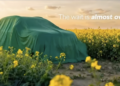 Skoda Kushaq facelift teaser showing SUV covered under green cloth in field
