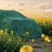 Skoda Kushaq facelift teaser showing SUV covered under green cloth in field